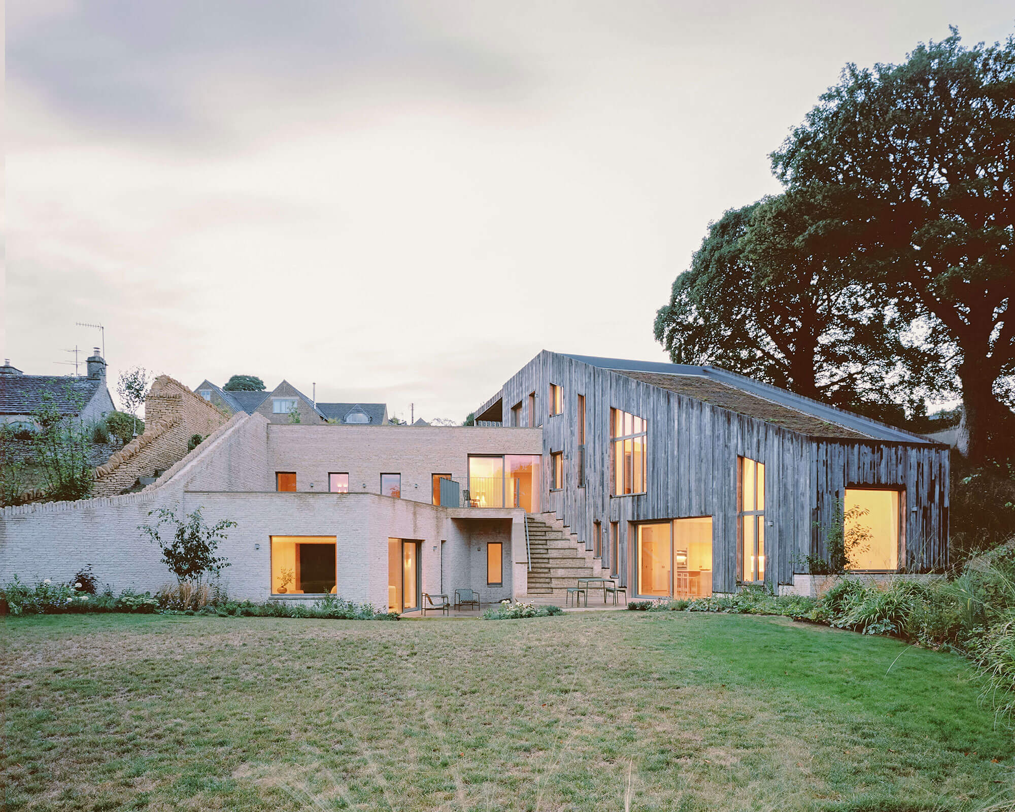 A photo of Oolite house from its garden, a traditional meets modern Cotswold architecture-style home.